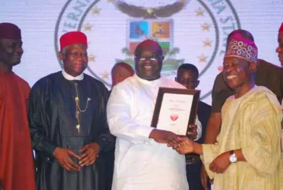 Okezie Ikpeazu,governor of Abia state(middle) receiving his award from Sam Amuka-Pemu