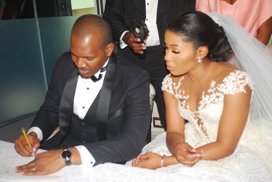 The Couple signing the marriage register