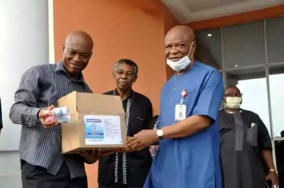 Prof. Iwu receiving the sanitizers from Prof. Onyebinama on behalf of Governor Uzodimma of Imo State