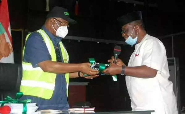 Governor of Imo State, Senator Hope Uzodimma (left) receiving report documents from Prof. Chinedu Nebo, Chairman of IMSU Visitation Panel at Sam Mbakwe Exco Chamber, Government House.