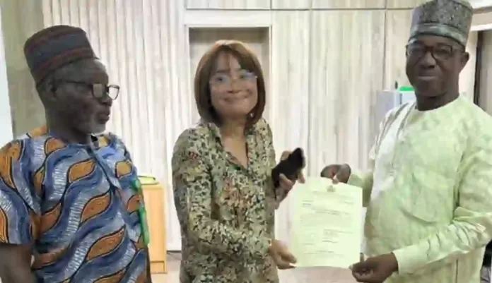 Evans Ikoku niece - receiving allocation paper from the ministry