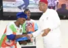 Gov. Uzodimma Uplifts 6,030 Newly Recruited Teachers (PHOTOS) Gov Uzodimma handing over a computer tablet to one of the newly recruited teachers.